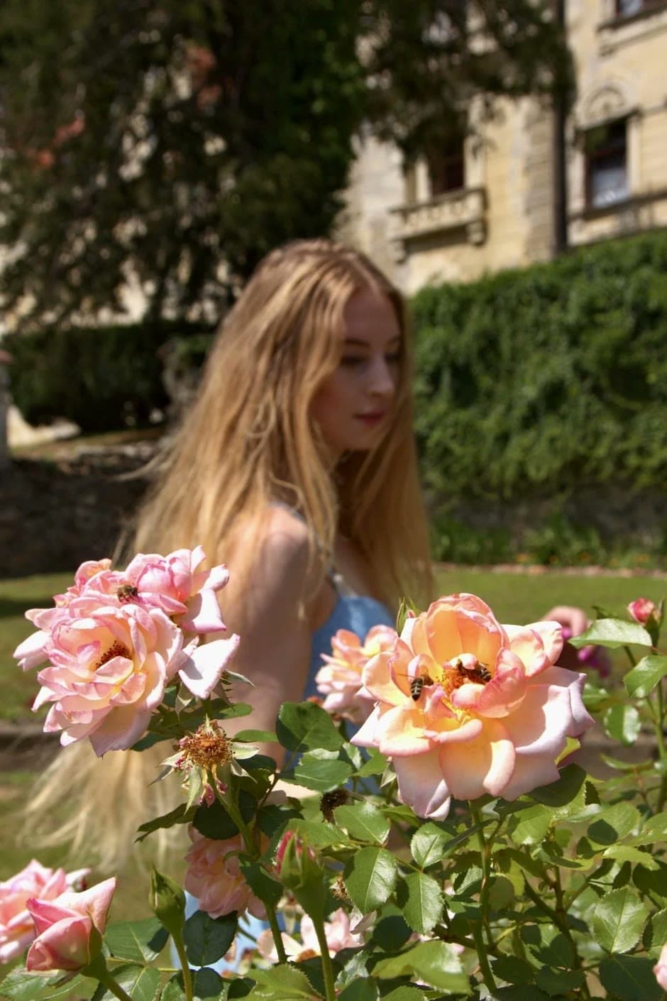 Urška among the roses, softly out of focus