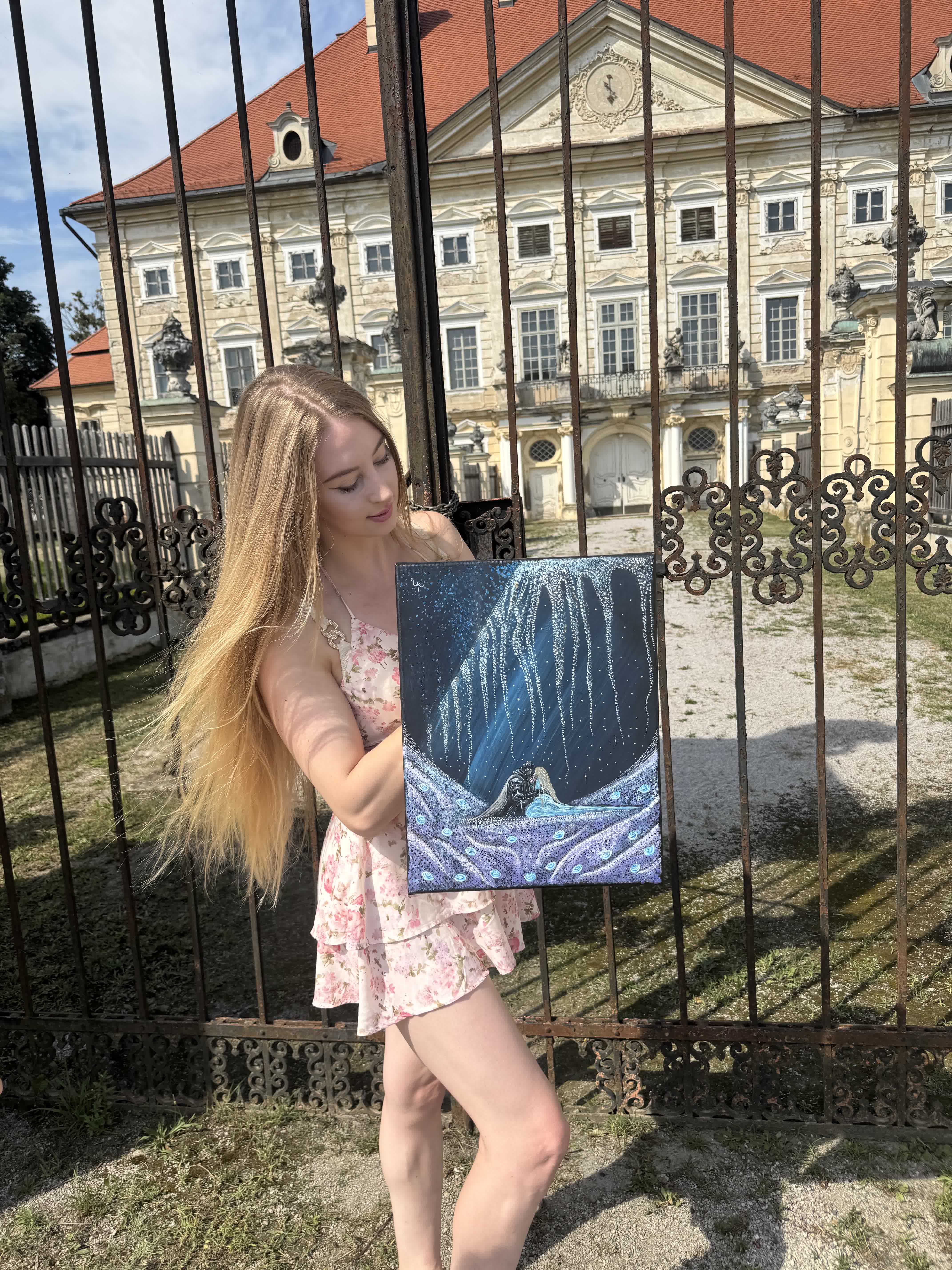 Urška holding the finished 'Blossoming Love' canvas