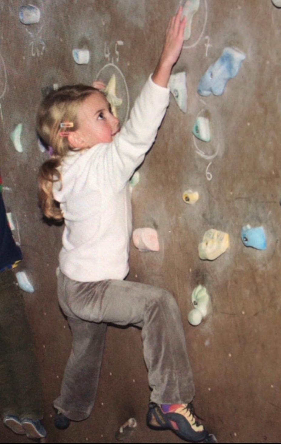 Urška as a child on an indoor climbing wall