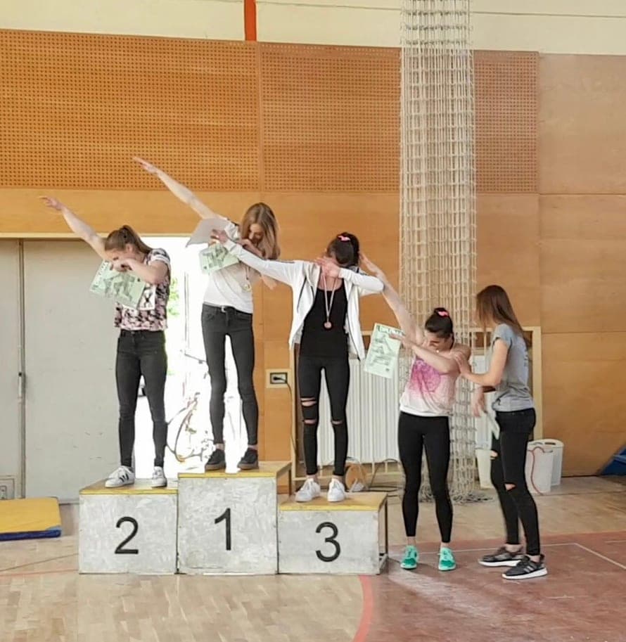 Urška on the podium between the second and third place climbers