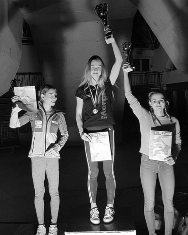 Urška raising her trophy on the podium