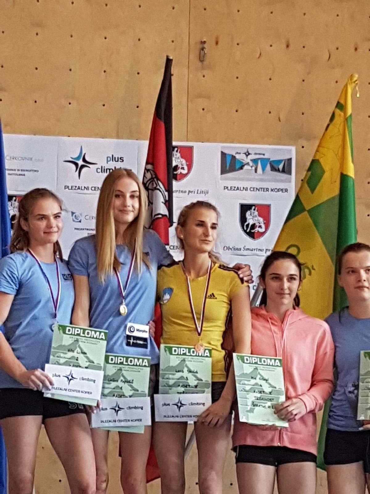 Urška with her medal and diploma among the winners
