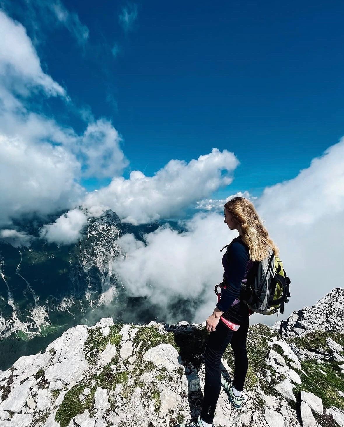 Urška on a summit above a sea of clouds