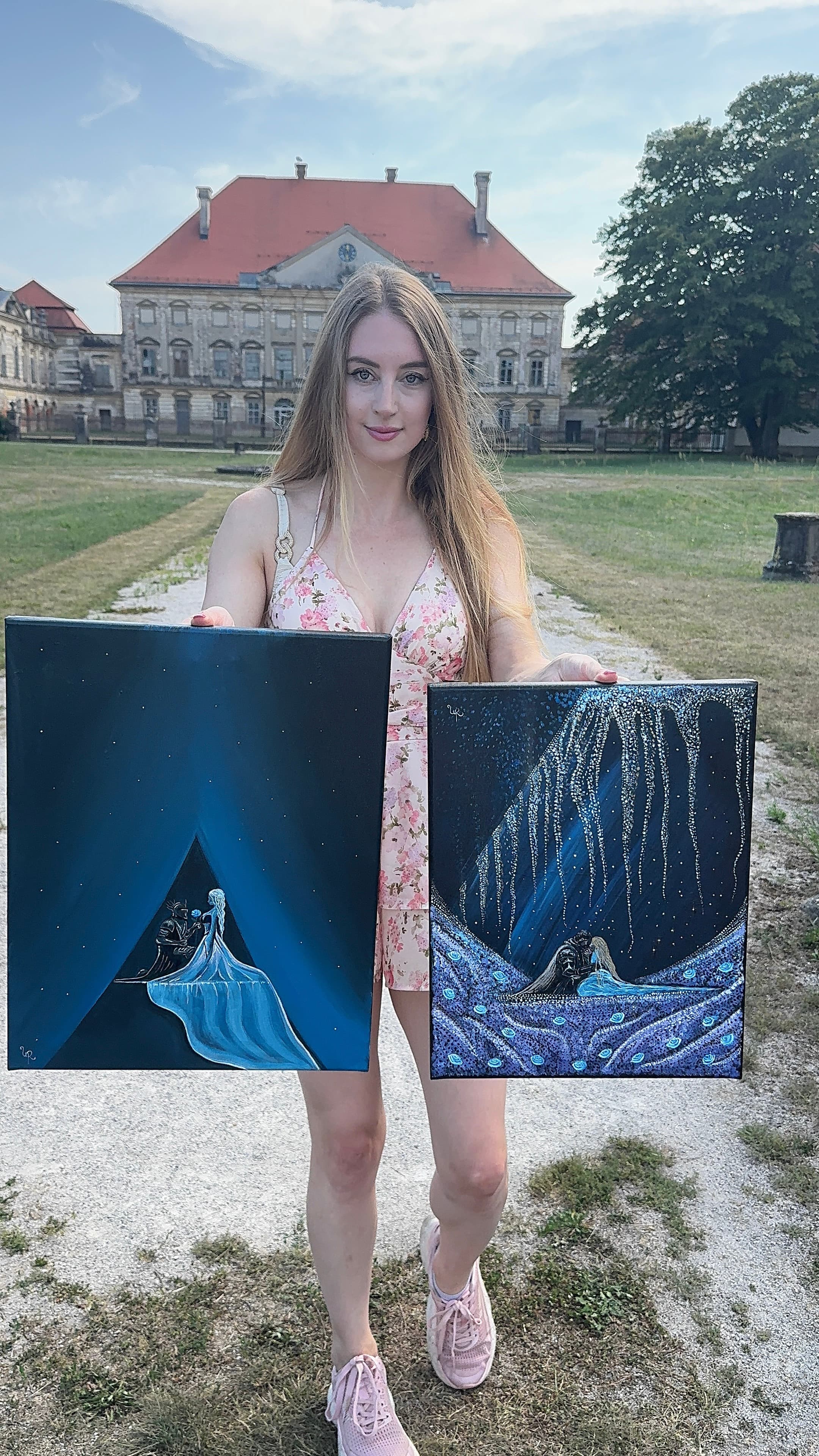 Urška holding the finished 'Eternal Love' canvas outdoors, alongside 'Blossoming Love'