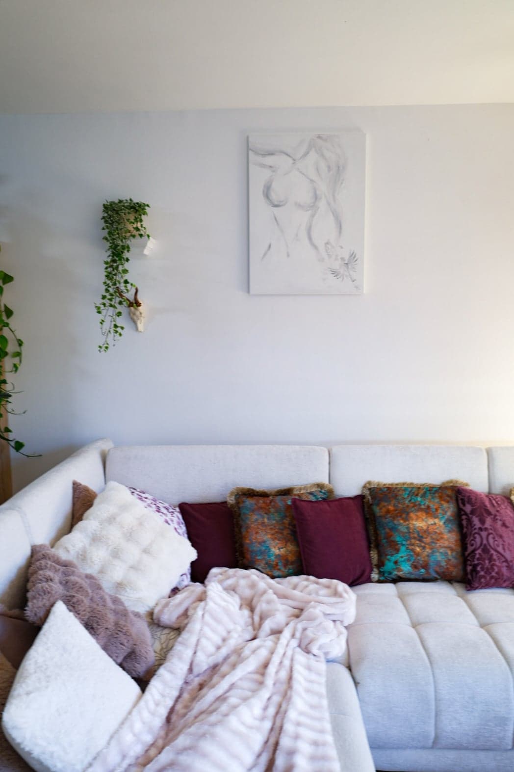 'Becoming' on a white wall above the sofa