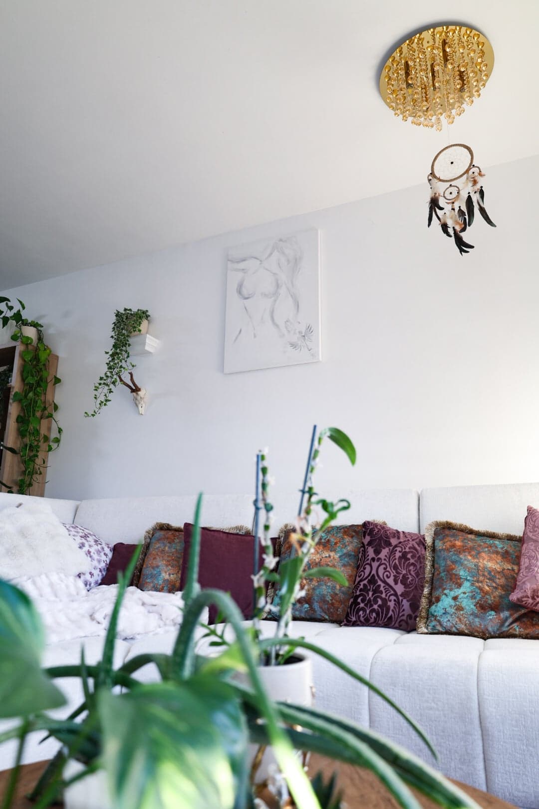 'Becoming' in the living room, below a beaded ceiling light